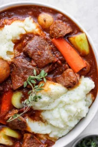 guiness beef stew over mashed potatoes