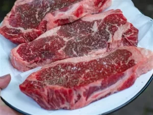 steaks seasoned with salt and pepper